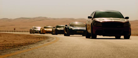 A dynamic scene from Furious 7 featuring a lineup of high-performance cars speeding along a winding desert road, captured in stunning HD quality for your desktop wallpaper.