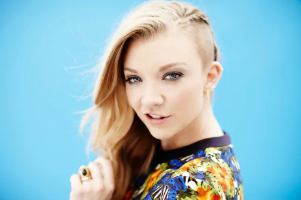 A striking HD wallpaper featuring celebrity Natalie Dormer, showcasing her unique style and captivating expression against a vibrant blue background.