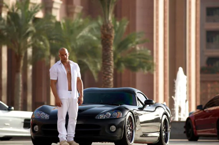 HD desktop wallpaper of Vin Diesel as Dominic Toretto in Furious 7, standing next to a sleek black car with luxurious architecture and palm trees in the background.