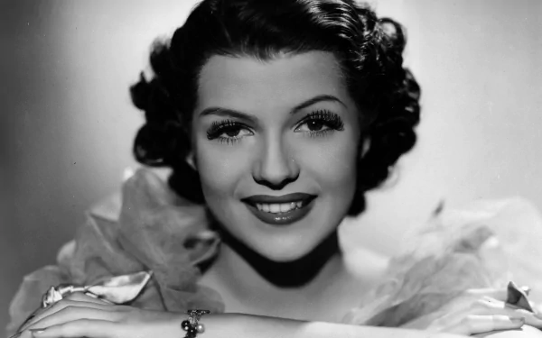 Black-and-white HD PC desktop wallpaper/background: close-up portrait of a smiling woman in classic Hollywood 1940s style, curled hair, ruffled collar and an elegant bracelet.