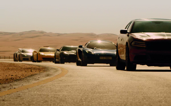 A dynamic scene from Furious 7 featuring a lineup of high-performance cars speeding along a winding desert road, captured in stunning HD quality for your desktop wallpaper.