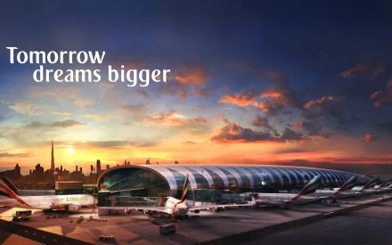 HD PC desktop wallpaper showing an Airbus A380 at an airport terminal during a dramatic sunset with the text Tomorrow dreams bigger.
