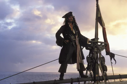 HD desktop wallpaper featuring Johnny Depp as Jack Sparrow from the movie Pirates of the Caribbean: The Curse of the Black Pearl, standing on a ship's mast against a dramatic sky backdrop.