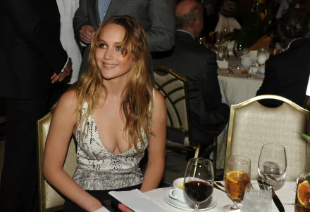 HD PC desktop wallpaper featuring celebrity Jennifer Lawrence smiling at a formal event, seated at a table with drinks and dinnerware.