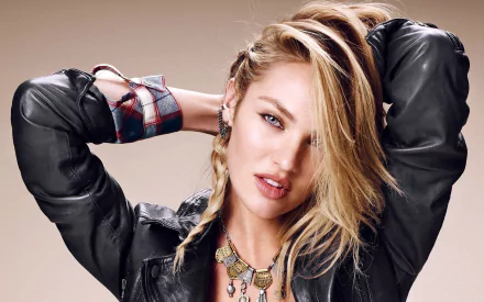 HD desktop wallpaper of a woman, tagged as Candice Swanepoel, featuring her with blonde hair, wearing a leather jacket, accessorized with a necklace, and posing with her hands behind her head.