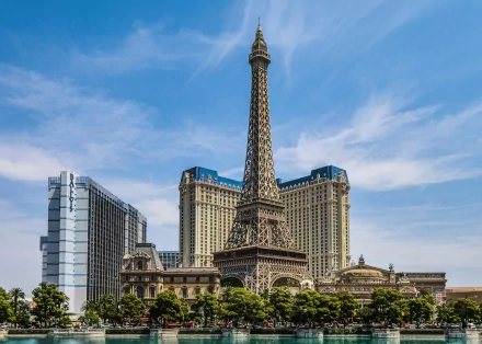 HD desktop wallpaper of the man-made Paris Las Vegas hotel with its replica Eiffel Tower and casino buildings against a bright blue sky.