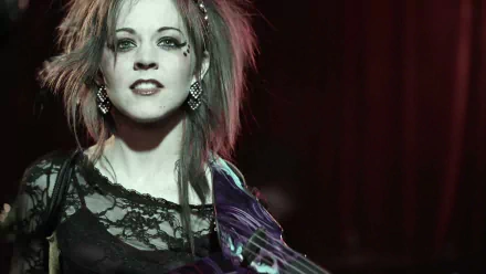HD PC desktop wallpaper featuring musician Lindsey Stirling with dramatic lighting and a dark background.