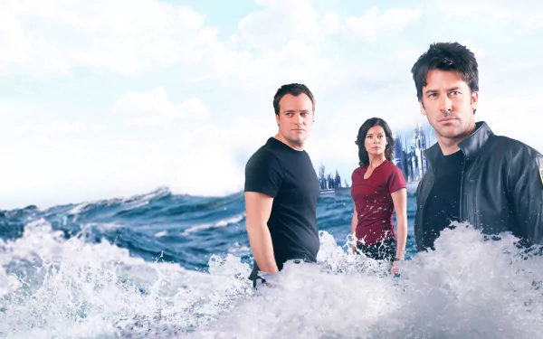 HD PC desktop wallpaper of the TV show Stargate Atlantis: three characters standing amid crashing ocean waves with a distant city skyline under a cloudy sky.