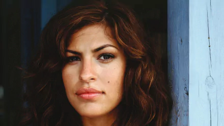 HD desktop wallpaper featuring a close-up portrait of celebrity Eva Mendes with soft lighting and a neutral background.