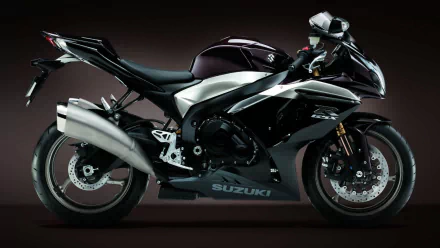 HD desktop wallpaper featuring a sleek black Suzuki GSX-R1000 sport motorcycle against a dark background.