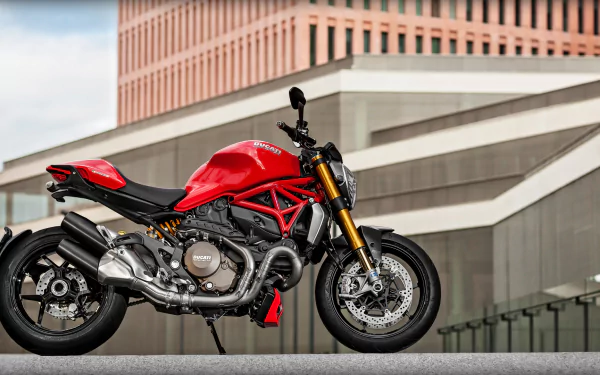 Vehicle: red Ducati motorcycle against modern urban architecture — HD PC desktop wallpaper background.