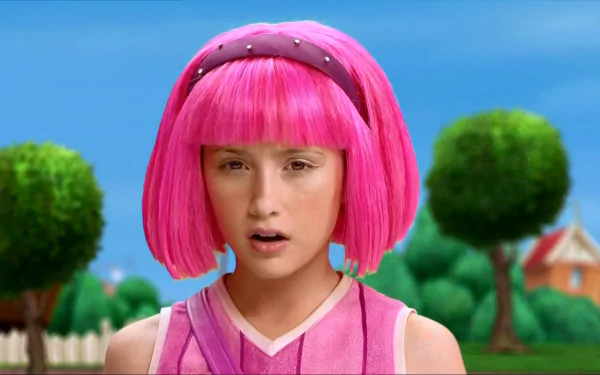 HD PC desktop wallpaper of Stephanie from the TV show LazyTown — close-up of her bright pink bob and pink outfit against a sunny, tree-lined suburban background.