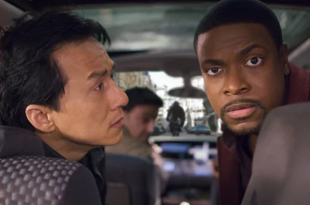A HD desktop wallpaper featuring Jackie Chan and Chris Tucker from the movie Rush Hour 3, showing a tense moment inside a car with blurred action in the background.