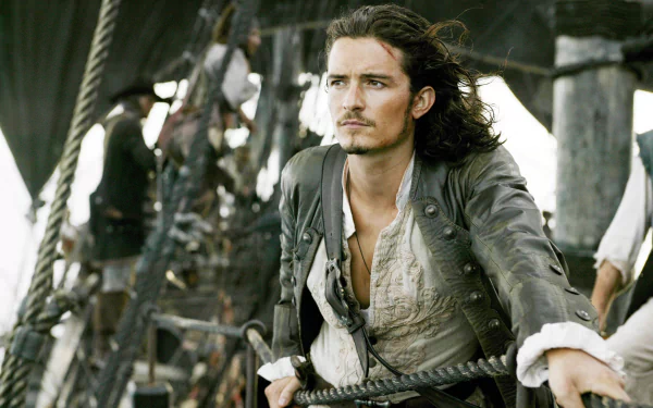 HD desktop wallpaper featuring Orlando Bloom as Will Turner from the movie Pirates of the Caribbean: Dead Man's Chest aboard a ship.