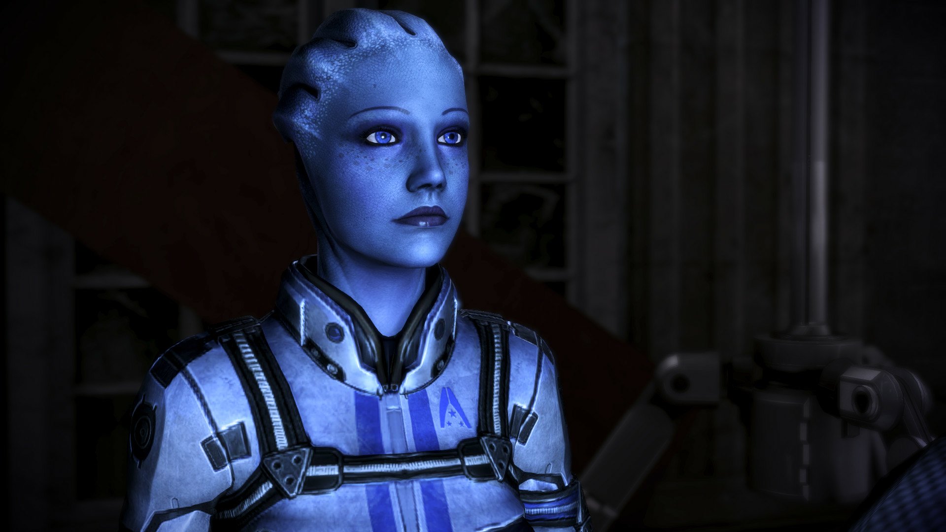 HD desktop wallpaper featuring Liara T'Soni from Mass Effect, poised thoughtfully in a dimly lit environment.