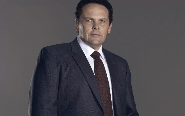 Kevin Chapman as a character from the TV show Person of Interest, captured in a 4K Ultra HD desktop wallpaper with a serious expression and formal suit.