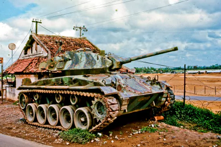 HD desktop wallpaper featuring an M24 Chaffee tank from the Vietnam War, set against a rural military backdrop with blue skies and scattered clouds.