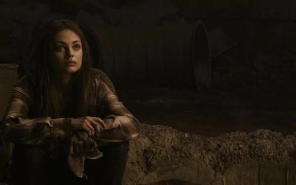 HD desktop wallpaper featuring Mila Kunis in a scene from the movie The Book of Eli, set in a dark, gritty environment.