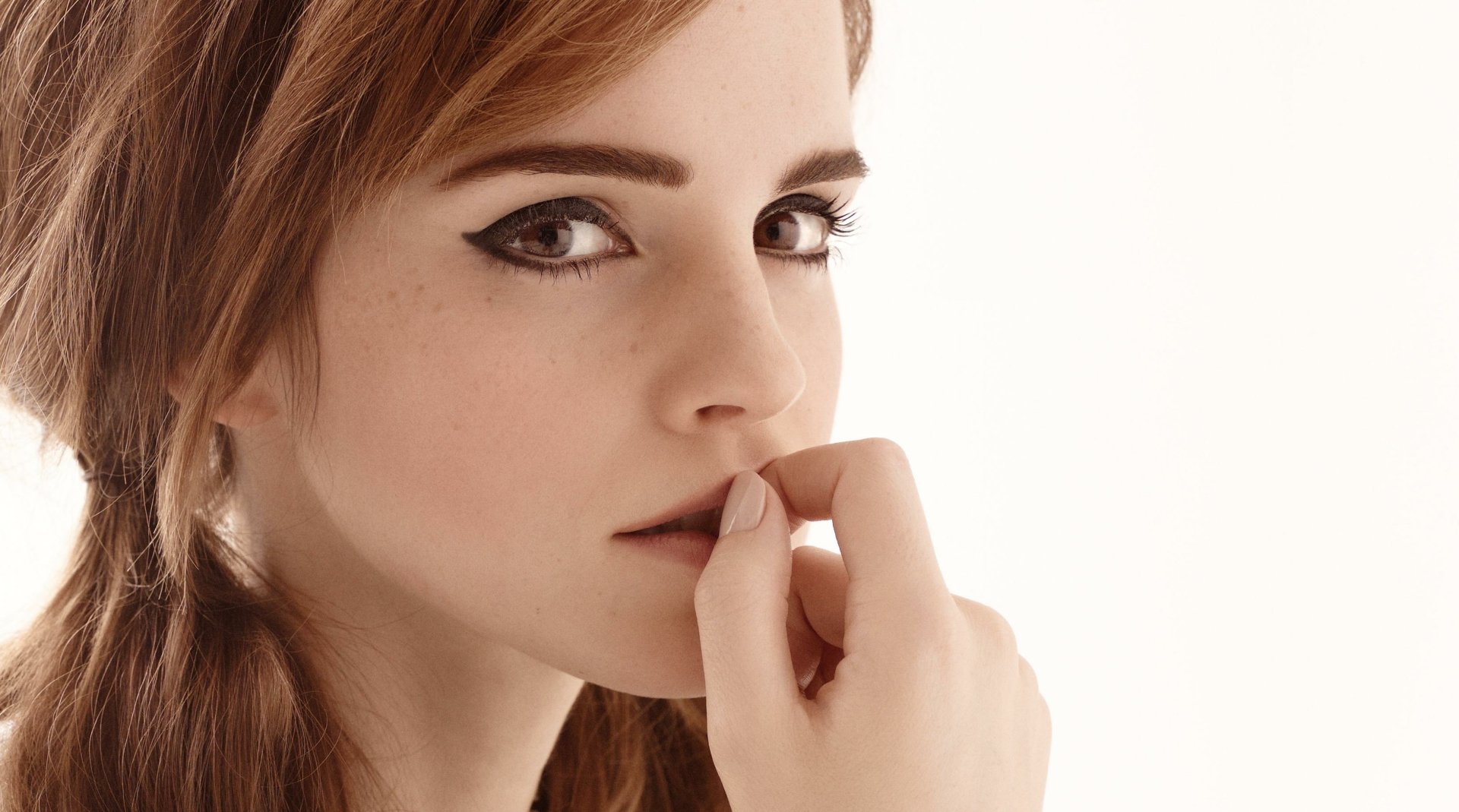 Emma Watson showcases a captivating gaze in this HD PC desktop wallpaper, featuring her signature style and expressive features against a soft, neutral background.