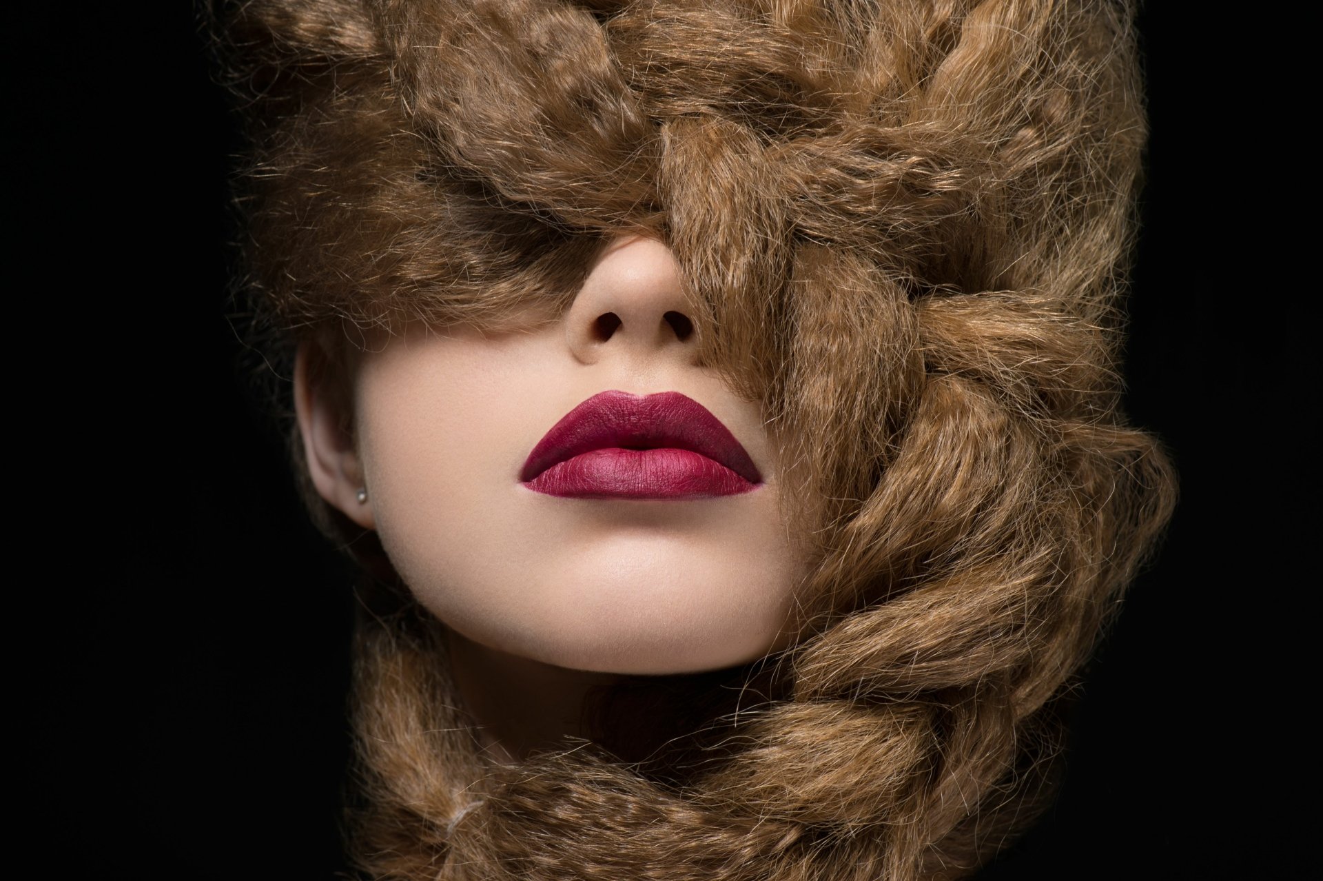 Close-up of a woman whose thick, braided hair covers her face, vivid red lips — 4K Ultra HD PC Desktop Wallpaper and Background.