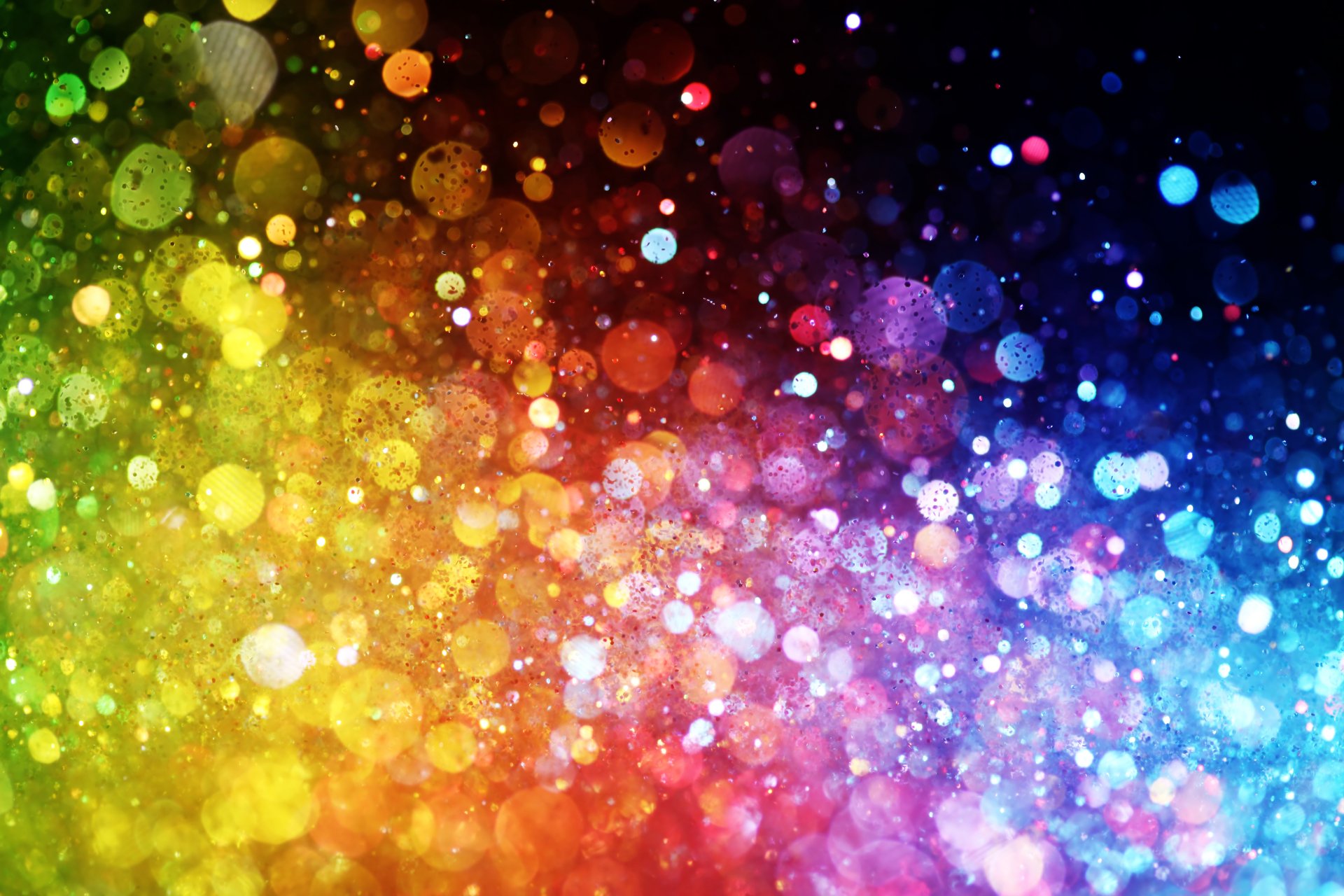 Artistic bokeh burst of rainbow lights across a 5K Ultra HD PC desktop wallpaper background, shimmering multicolored circles and soft glowing particles.