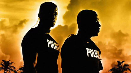 HD PC desktop wallpaper featuring two police officers silhouetted against a dramatic orange sky, inspired by the movie Bad Boys II.