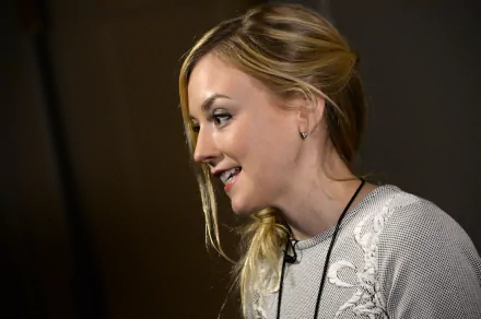 HD desktop wallpaper featuring American singer and actress Emily Kinney smiling against a dark background.