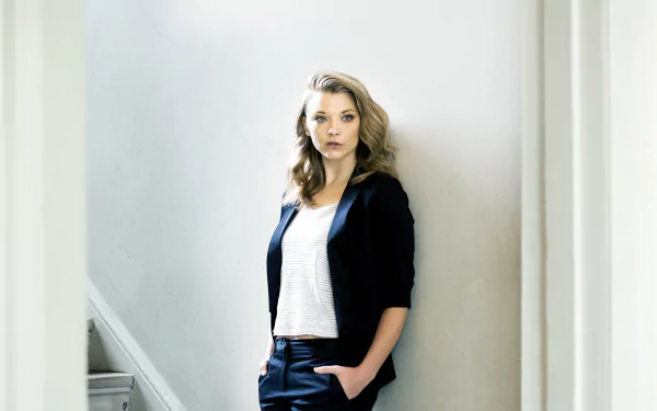 4K Ultra HD desktop wallpaper featuring celebrity Natalie Dormer standing confidently against a light-colored wall, dressed in a black blazer and white top.