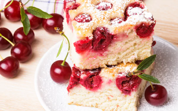A delicious cherry pastry stacked on a plate, surrounded by fresh cherries, showcasing a tempting dessert that's visually appealing as a 4K Ultra HD desktop wallpaper.