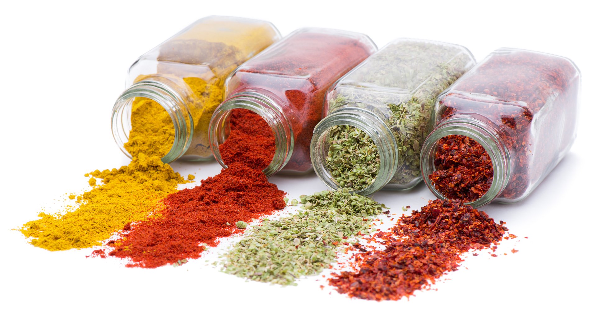 5K Ultra HD PC desktop wallpaper of food herbs and spices: five glass jars spilling vibrant ground spices and dried herbs across a white background.