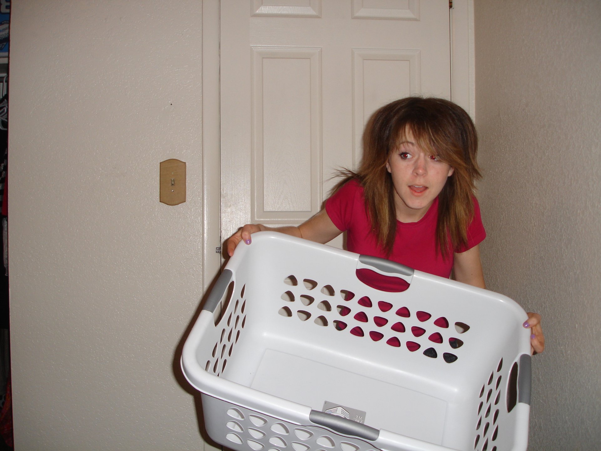 HD PC desktop wallpaper featuring Lindsey Stirling holding a white laundry basket against a plain indoor background, connected to music and her energetic style.