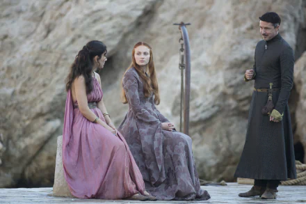 Sophie Turner as Sansa Stark and Aidan Gillen as Petyr Baelish in a 4K Ultra HD Game of Thrones scene, set outdoors with historic costumes and a rocky background.