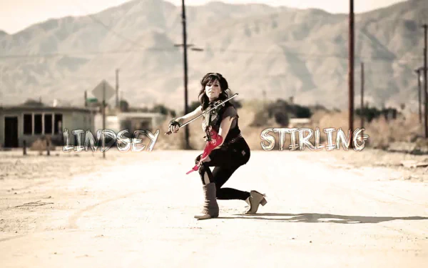 HD PC desktop wallpaper featuring musician Lindsey Stirling playing violin in a desert landscape with mountains in the background.