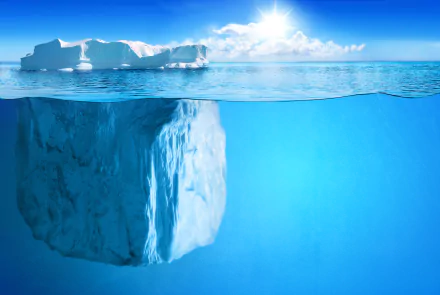 A stunning 4K Ultra HD image of an iceberg floating in a crystal-clear ocean, showcasing the beautiful interplay of ice and water in nature under a bright sky.