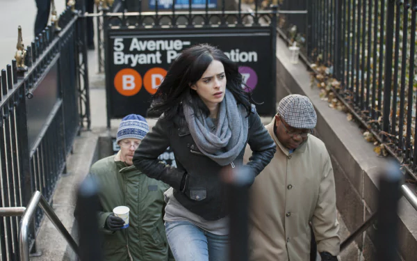 Krysten Ritter as Jessica Jones walking up from a subway entrance in a 4K Ultra HD TV show wallpaper background.
