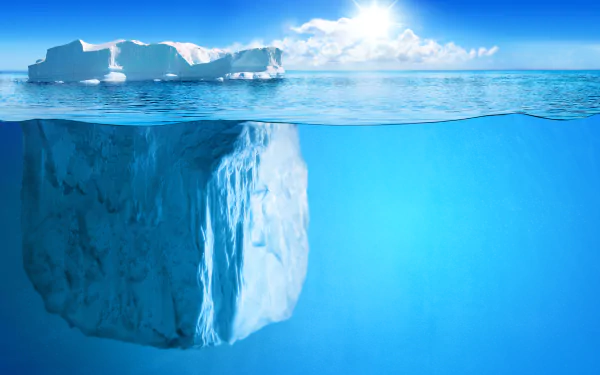A stunning 4K Ultra HD image of an iceberg floating in a crystal-clear ocean, showcasing the beautiful interplay of ice and water in nature under a bright sky.