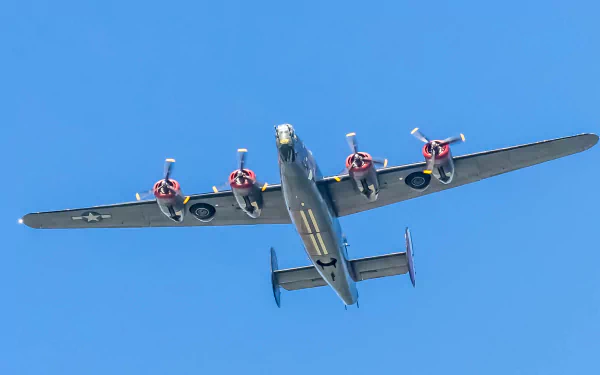 HD desktop wallpaper featuring a Consolidated B-24 Liberator military bomber aircraft flying against a clear blue sky.