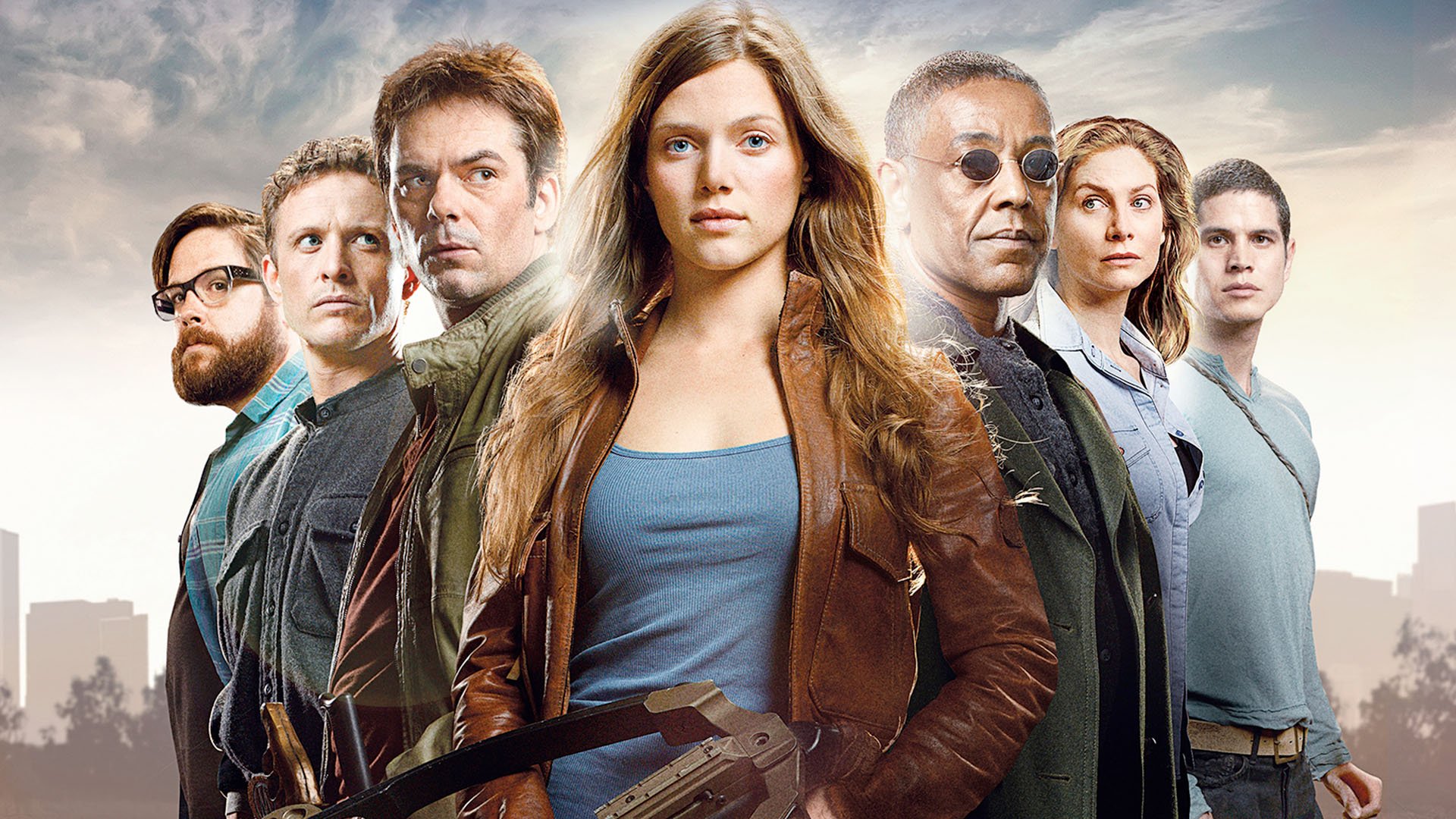 HD PC desktop wallpaper featuring the main cast of the TV show Revolution standing together against a cloudy sky backdrop.