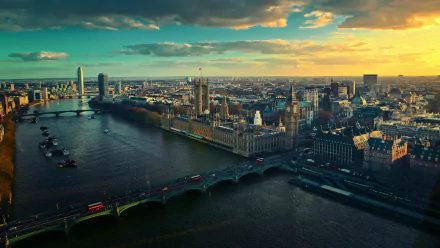 A stunning HD wallpaper showcasing a panoramic view of London at sunset, featuring iconic buildings along the River Thames and the famous bridges connecting the city.