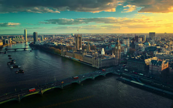 A stunning HD wallpaper showcasing a panoramic view of London at sunset, featuring iconic buildings along the River Thames and the famous bridges connecting the city.