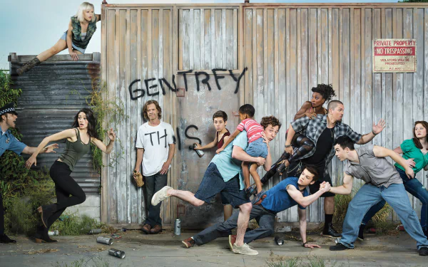 A vibrant HD wallpaper featuring the eclectic cast of the TV show Shameless, capturing their dynamic energy against a graffiti-adorned backdrop.