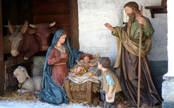 A serene nativity scene depicting Mary, Joseph, and baby Jesus, surrounded by animals, capturing the essence of the Christmas holiday in a vibrant HD desktop wallpaper.