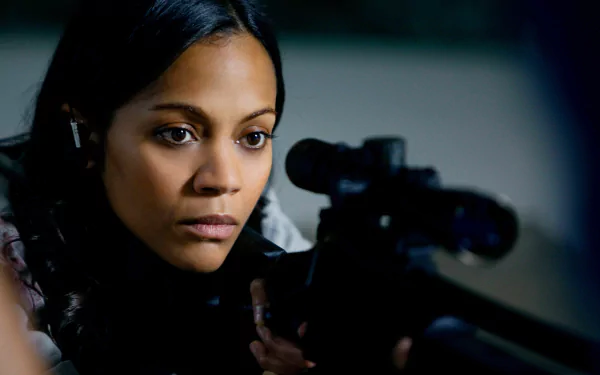 Zoe Saldana as Cataleya in the movie Colombiana, aiming through a sniper rifle, captured in a detailed 4K Ultra HD PC desktop wallpaper.