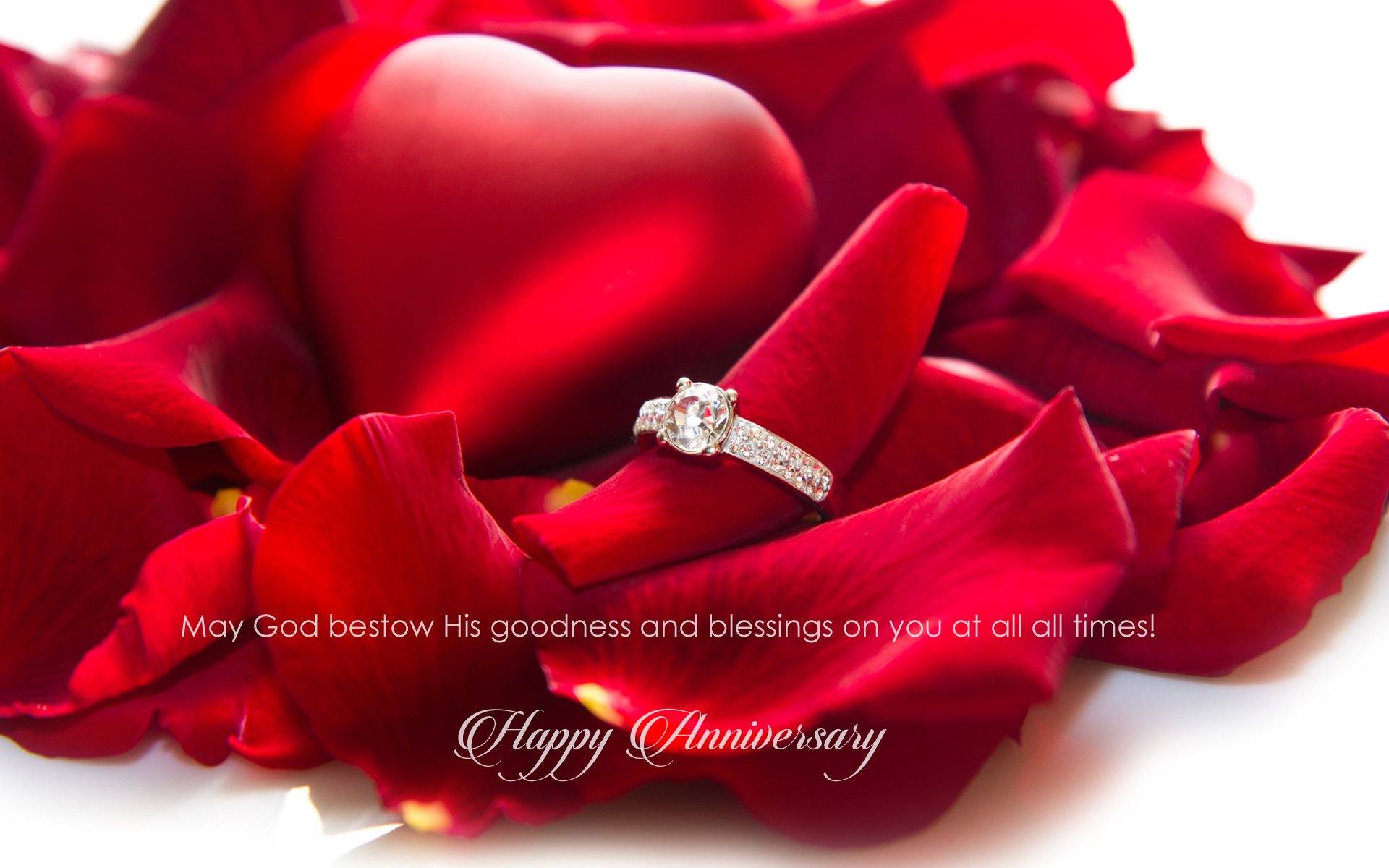 HD PC desktop wallpaper: red rose petals cradling a heart-shaped cushion and a diamond ring, anniversary holiday greeting on a romantic floral background.