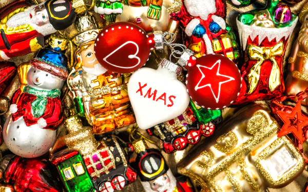 A vibrant 4K Ultra HD Christmas desktop wallpaper showcasing colorful holiday ornaments, including snowmen, stars, hearts, and festive figurines.