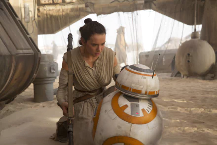 Rey (Daisy Ridley) and BB-8 in a scene from Star Wars Episode VII: The Force Awakens. This HD desktop wallpaper captures the iconic characters from the movie set in a desert environment.