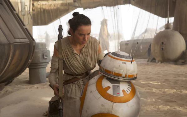 Rey (Daisy Ridley) and BB-8 in a scene from Star Wars Episode VII: The Force Awakens. This HD desktop wallpaper captures the iconic characters from the movie set in a desert environment.