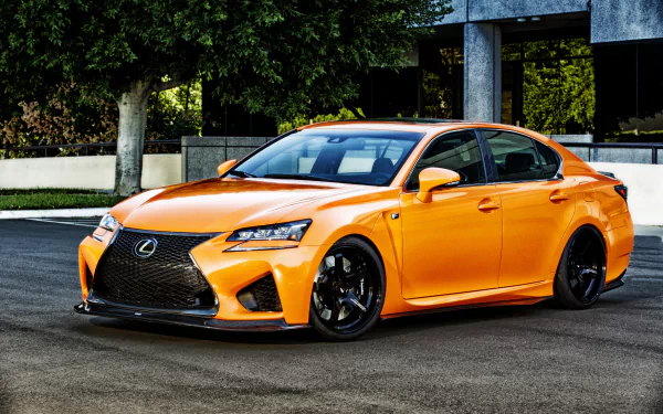 HD desktop wallpaper featuring a vibrant orange Lexus GS car parked on a street, showcasing the vehicle’s sleek design and sporty appeal.