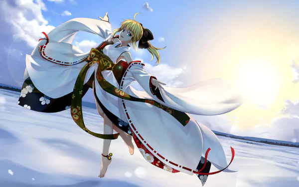 A blonde character with green eyes and a ponytail wears a flowing white dress inspired by Japanese clothing. She poses dynamically against a bright, sunny background in this Fate/Stay Night wallpaper.
