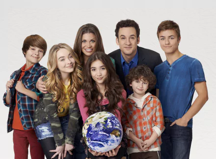 4K Ultra HD Disney desktop wallpaper for the TV show Girl Meets World: seven smiling characters posed on a white backdrop, the center girl holding a globe.